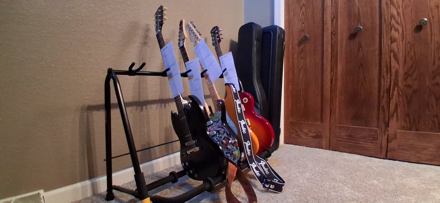Several electric guitars on stands waiting for service.