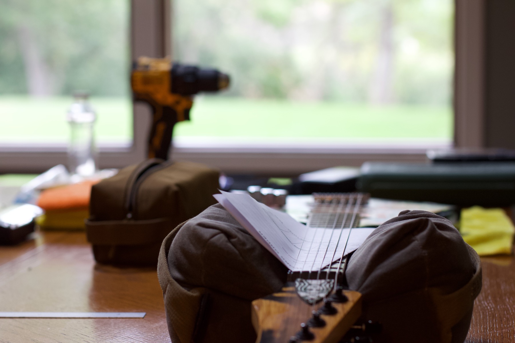 Sticker-covered electric guitar staged on a table with setup tools ready for a guided teaching session.
